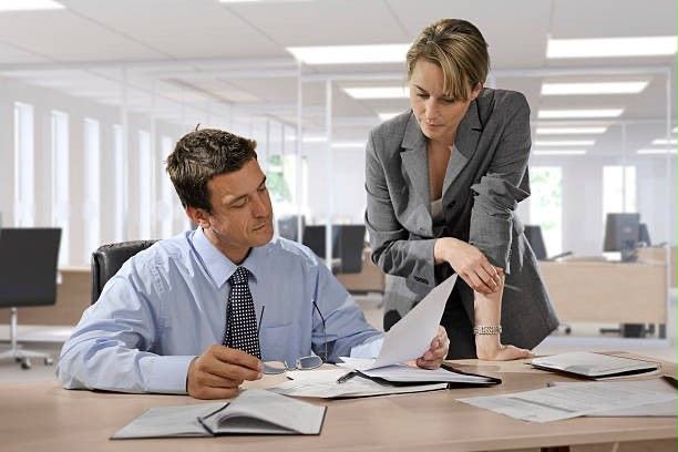 Bank staff reviewing documents in an office